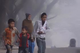 people protecting themselves from cold in a hut.